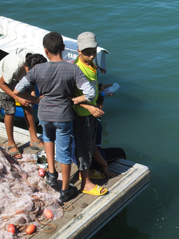 Boys fishing in the Oued Bou Regreg river in Rabat Morocco