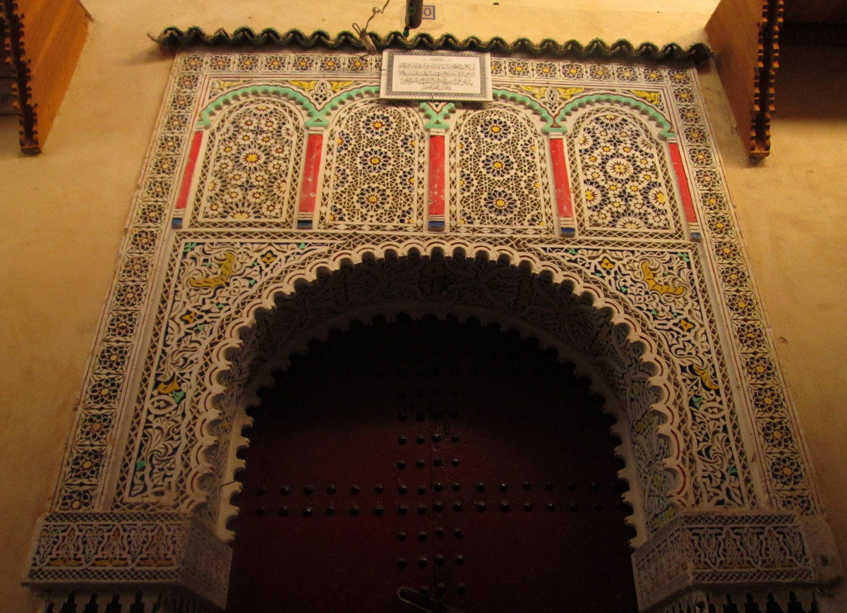 Ornate carvings on a doorway in the medina of Meknes Morocco