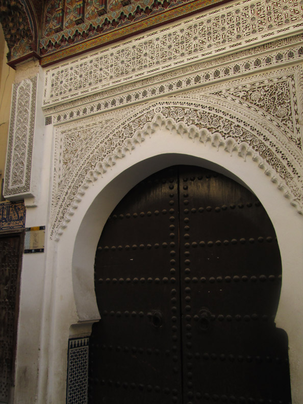 Ornate carvings on a doorway in the medina of Meknes Morocco