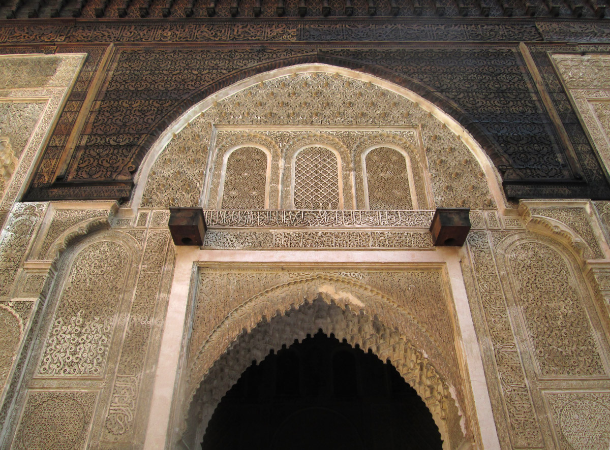 A stucco and wood doorway in the Medersa Bou Inania in Fes Morocco