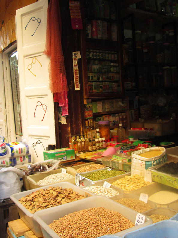 A vendor selling nuts and dried fruit in the souks of Fes Morocco