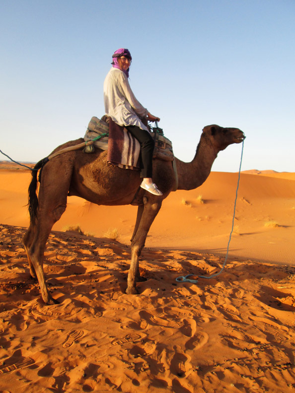 girl on a camel in the Sahara Desert near Merzouga Morocco